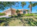 Charming single-story home with well-maintained lawn, mature palm trees, and attached two-car garage at 2625 Wax Myrtle, Port Charlotte, FL 33953