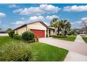 A well-maintained single-Gathering home showcases lush landscaping and a beautiful brick driveway at 2628 Sherman Oak Dr, North Port, FL 34289