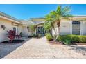 Inviting front entrance with paver walkway and lush landscaping at 3574 Pennyroyal Rd, Port Charlotte, FL 33953