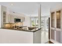 Well-equipped kitchen with granite countertops, stainless steel appliances, and a breakfast nook at 38 Seawatch Lake Dr, Boca Grande, FL 33921