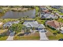Expansive aerial view of a home near a lake, showcasing the pool and surrounding lush landscaping at 4 Sportsman Ln, Rotonda West, FL 33947