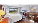 Serene bedroom with a private screened-in patio, complete with a ceiling fan and a scenic outdoor view at 4260 Placida Rd # 8D, Englewood, FL 34224