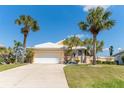 Charming single Gathering home with a white tile roof, lush landscaping and a two car garage at 6 Windward Ct, Placida, FL 33946
