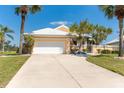 Charming single Gathering home with a white tile roof, lush landscaping and a two car garage at 6 Windward Ct, Placida, FL 33946