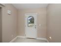Bright foyer featuring tile flooring and a glass-paneled front door at 6368 Pennell St, Englewood, FL 34224