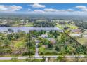Waterfront property featuring mature landscaping and access to a serene lake perfect for relaxation at 730 Buckskin Ct, Englewood, FL 34223