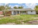 A charming one-story home features a well-kept lawn and a two car garage at 730 Buckskin Ct, Englewood, FL 34223