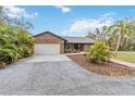 Charming brick home with mature landscaping and a spacious driveway offers curb appeal at 746 Brentwood Dr, Venice, FL 34292