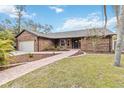 Brick home with landscaped walkway and manicured lawn is move-in ready at 746 Brentwood Dr, Venice, FL 34292