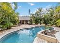 Backyard pool surrounded by lush landscaping offers a private oasis at 746 Brentwood Dr, Venice, FL 34292