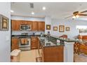 Kitchen features wood cabinetry, granite countertops and breakfast bar at 8409 Placida Rd # 305, Placida, FL 33946