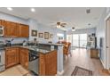 Living room with wood floors flowing into an open concept kitchen and access to private balcony at 8409 Placida Rd # 305, Placida, FL 33946