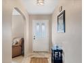 Inviting front foyer featuring neutral walls, tiled floors, and a stylish accent table at 9260 Saint Catherine Ave, Englewood, FL 34224