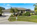 A well manicured front lawn leads up to this single story home with lush landscaping and a large driveway at 12432 Nova Ave, Port Charlotte, FL 33981