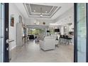 Open living room showcases tile flooring, high ceilings, and stylish furnishings with backyard view at 13379 Journal Ln, Port Charlotte, FL 33981