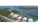 Aerial view of waterfront condos with a marina and beautiful water views at 1420 Beach Rd # 203, Englewood, FL 34223