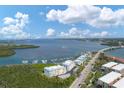 Aerial view showing waterfront condo, neighborhood, and local marina at 1420 Beach Rd # 203, Englewood, FL 34223