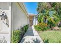 Inviting walkway leading to the home's entrance with manicured shrubs and plants at 14270 Reserve Ct, Port Charlotte, FL 33953