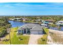 Breathtaking aerial view of a waterfront home with lush greenery and boat docks, a serene retreat at 14286 Fort Worth Cir, Port Charlotte, FL 33981