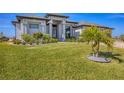Beautifully landscaped front yard with a palm tree adds tropical flair to this modern home at 14286 Fort Worth Cir, Port Charlotte, FL 33981