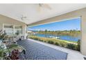 Covered patio with comfortable seating and a scenic waterfront view, perfect for outdoor relaxation at 15738 Applewhite Cir, Port Charlotte, FL 33981