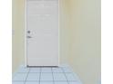 Clean entryway with white tiled floors and a crisp white door at 2 Bunker Way, Rotonda West, FL 33947
