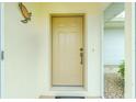 Close-up of the front door with decorative turtle and a welcoming mat at 2 Bunker Way, Rotonda West, FL 33947