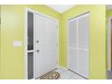 Bright foyer with neutral tones, closet, and a door with side-light panel, creating an inviting entry space at 20 Bunker Way, Rotonda West, FL 33947