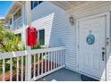 Inviting entrance featuring white door, house number, and well-kept surroundings at 200 Rotonda W Blvd # A2, Rotonda West, FL 33947