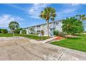 Exterior view showcasing well-manicured lawns and inviting building facade at 200 Rotonda W Blvd # A2, Rotonda West, FL 33947