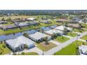 An aerial view of the homes in the neighborhood, showing a pond, golf course and beautiful landscaping at 25 Medalist Ter, Rotonda West, FL 33947