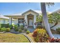 Welcoming front porch with seating and vibrant landscaping adding to the home's curb appeal at 25 Medalist Ter, Rotonda West, FL 33947