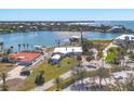 Panoramic aerial view of the waterfront property with tropical landscaping and sparkling blue water at 400 Anchor Row, Placida, FL 33946