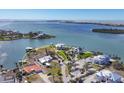 Picturesque aerial view of waterfront property featuring lush greenery, a dock, and a pool at 400 Anchor Row, Placida, FL 33946