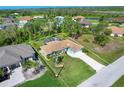 Aerial view of home showing screened pool, landscaping, and proximity to surrounding neighborhood at 5 Pine Valley Rd, Rotonda West, FL 33947