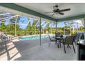 Screened-in patio with outdoor dining area overlooking a refreshing pool at 5 Pine Valley Rd, Rotonda West, FL 33947