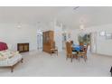 Open-concept living room and dining area with white walls and neutral carpeting at 51 Mark Twain Ln, Rotonda West, FL 33947