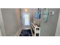 Inviting entryway with light gray walls, tile flooring, and stylish decor creating a welcoming ambiance at 5388 Montego Ln, Port Charlotte, FL 33981