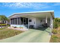 Inviting single-story residence with a covered carport, cozy front porch, and colorful, maintained landscaping at 5619 Bayshore Rd # 240, Palmetto, FL 34221