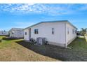 The rear exterior of the home reveals the utility area and minimalist landscaping at 5619 Bayshore Rd # 240, Palmetto, FL 34221