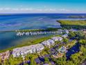 An aerial shot of a condo complex with a marina and pool, with a stunning view of the ocean at 5858 Gasparilla Rd # Mm40, Boca Grande, FL 33921