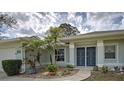 Inviting front entrance with colorful plants, decorative stone and secure double entry doors at 587 Viridian St, Englewood, FL 34223