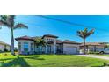 Inviting one-story house with a tile roof, palm trees, and a freshly cut lawn at 8144 Antwerp Cir, Port Charlotte, FL 33981