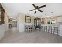 Bright living space with wood-look tile floors, ceiling fan, and a dining area with natural light at 9350 Prospect Ave, Englewood, FL 34224