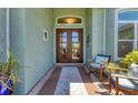 Inviting entryway with seating and a decorative rug leading to the front door at 10082 Army Cir, Port Charlotte, FL 33981