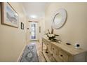 Inviting entryway with tile floors, decorative mirror, console table, and ornate front door at 10183 Winding River Rd, Punta Gorda, FL 33950