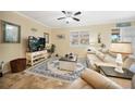 Comfortable living room featuring plush seating, a ceiling fan, and a cozy atmosphere at 10183 Winding River Rd, Punta Gorda, FL 33950