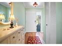 Welcoming entryway with hardwood floors, a decorative dresser, and a view of the front door and outside at 107 Jose Gaspar Dr, Englewood, FL 34223