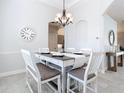 The light and bright dining room features stylish chandelier and lots of natural light at 12605 Bacchus Rd, Port Charlotte, FL 33981