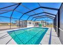 Screened pool with clear blue water and ample deck space for relaxation at 13 Caddy Rd, Rotonda West, FL 33947